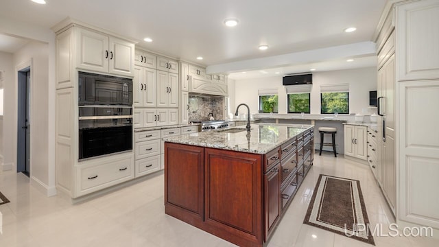 kitchen featuring black appliances, white cabinets, sink, backsplash, and light tile patterned flooring