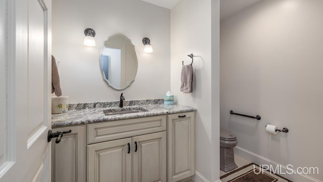 bathroom with vanity and toilet