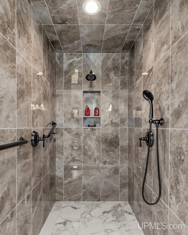 bathroom with a tile shower