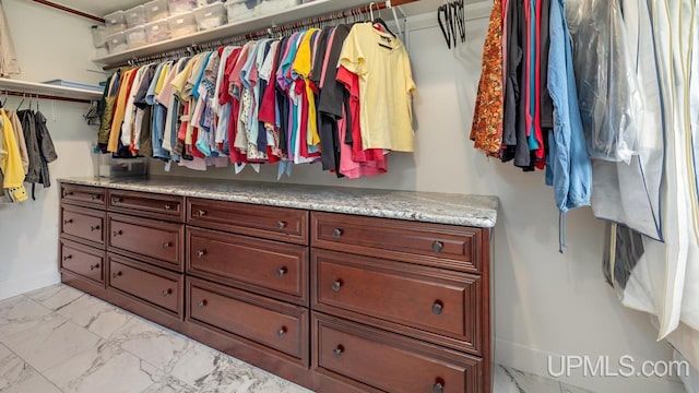 walk in closet featuring light tile patterned flooring