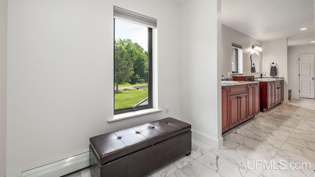 bathroom with dual vanity, tile patterned floors, and a baseboard heating unit