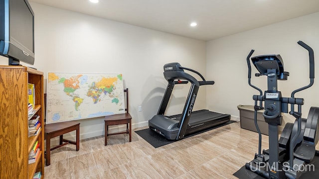 exercise room with light tile patterned flooring