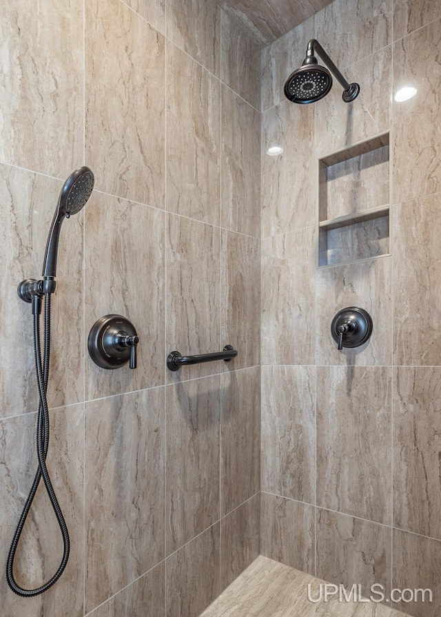 bathroom with a tile shower