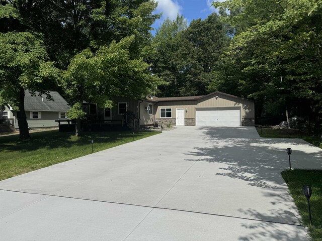 view of front of home with a garage and a front lawn