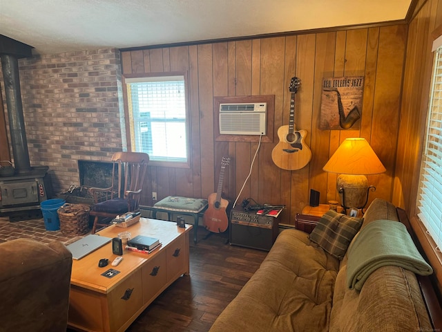 living room with an AC wall unit, a wood stove, dark hardwood / wood-style flooring, and wooden walls