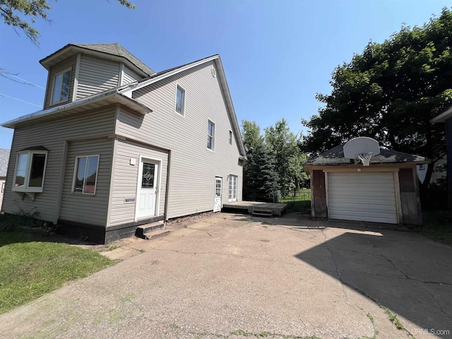 exterior space featuring a garage and an outdoor structure