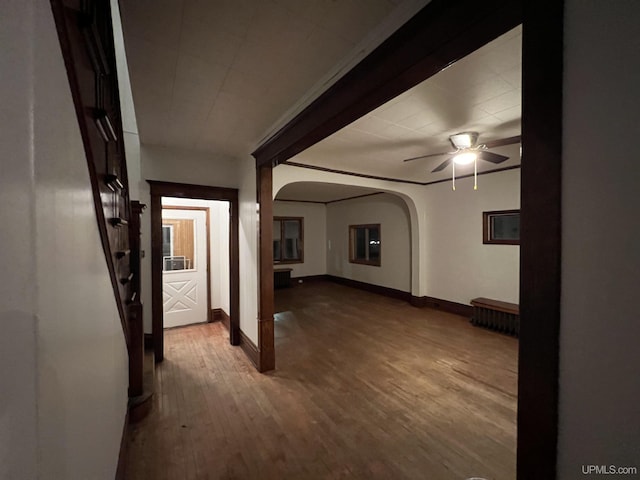 unfurnished living room with hardwood / wood-style flooring and ceiling fan