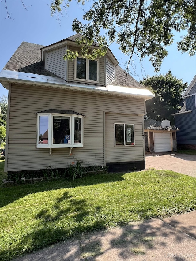 view of side of property with a garage and a yard