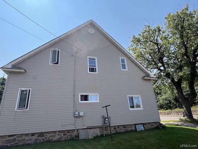 view of property exterior featuring a lawn