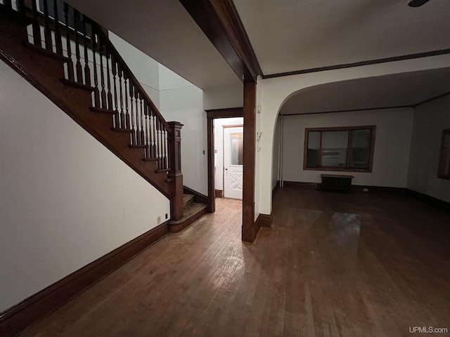 interior space featuring wood-type flooring and ornamental molding