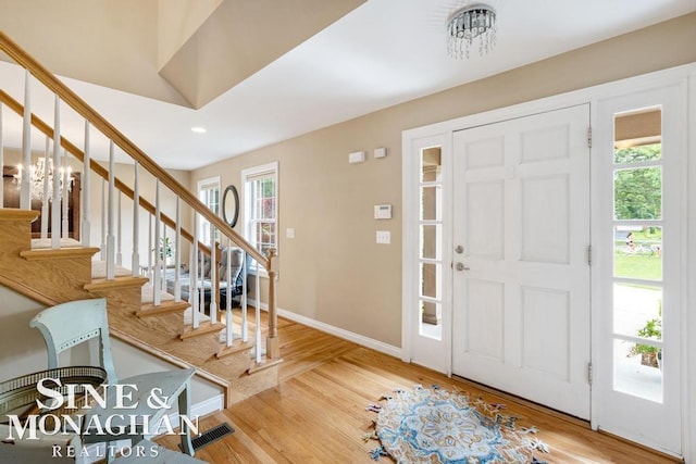 entryway with light hardwood / wood-style flooring and a healthy amount of sunlight