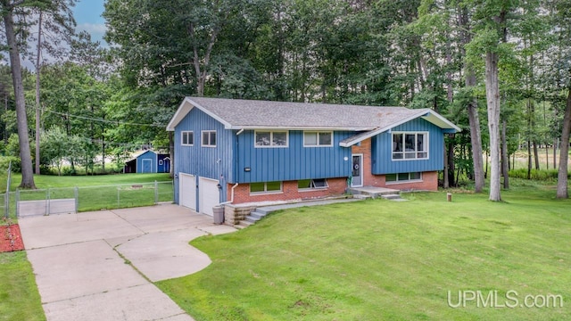 split foyer home with a garage and a front lawn