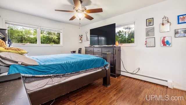 bedroom featuring a baseboard radiator, wood-type flooring, and ceiling fan