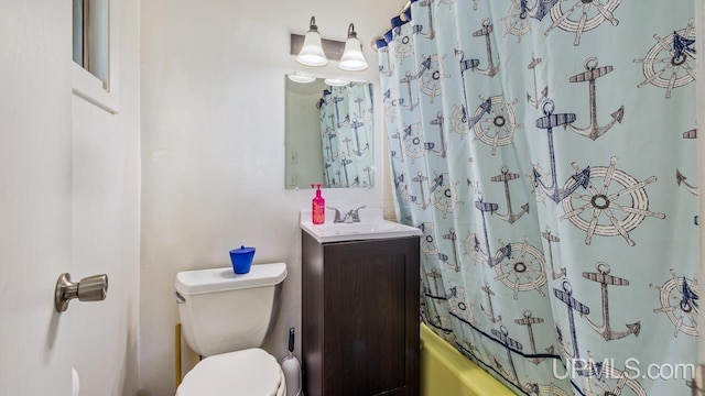 full bathroom with vanity, shower / bath combo with shower curtain, and toilet