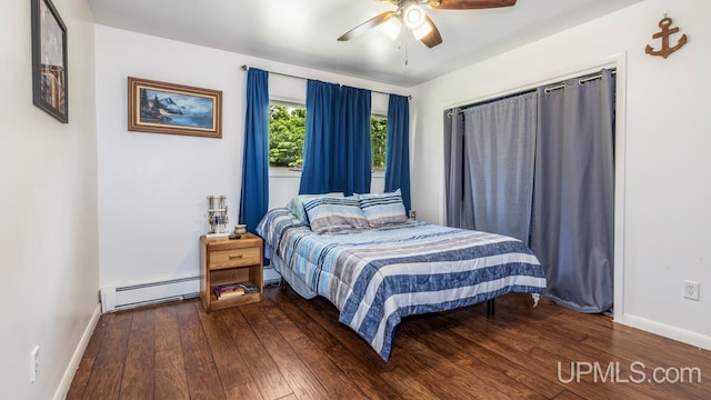 bedroom featuring ceiling fan, dark hardwood / wood-style flooring, and baseboard heating