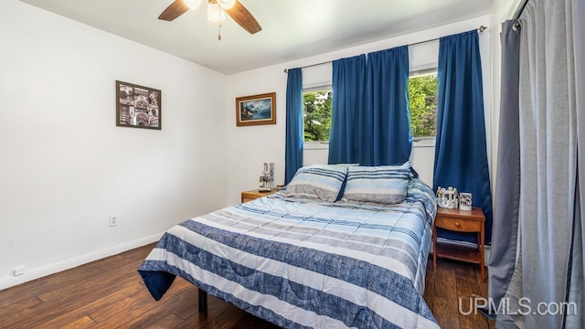 bedroom with dark wood-type flooring and ceiling fan