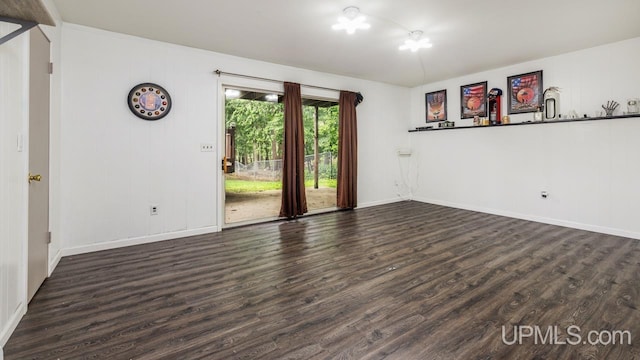 empty room with dark wood-type flooring