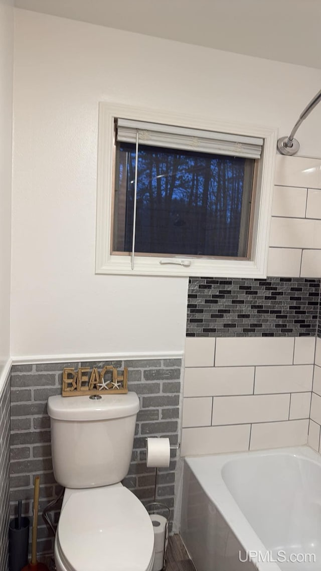 bathroom with shower / tub combination and toilet