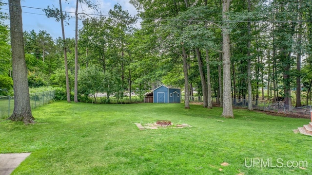 view of yard featuring a storage unit and a fire pit