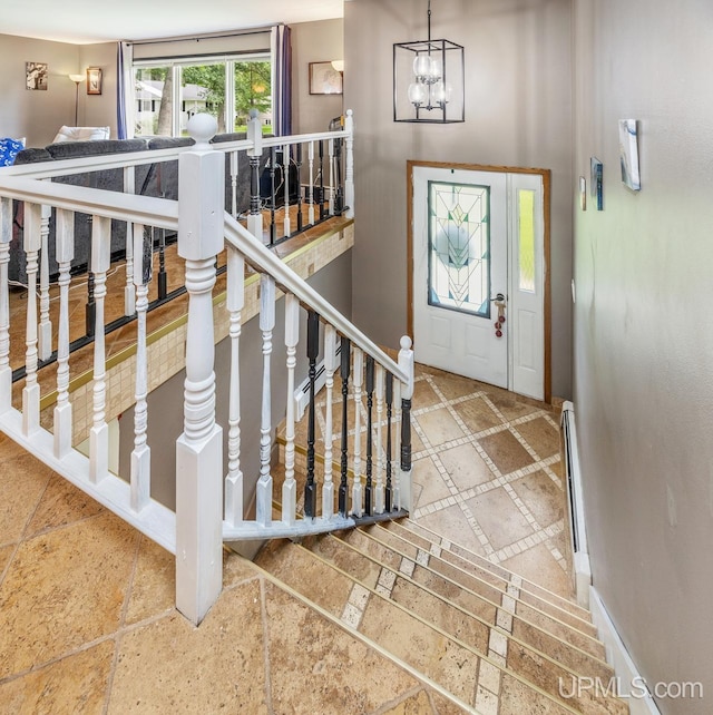 foyer entrance with a notable chandelier