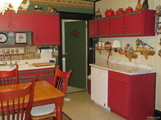 kitchen with light tile patterned floors, tasteful backsplash, sink, and an inviting chandelier