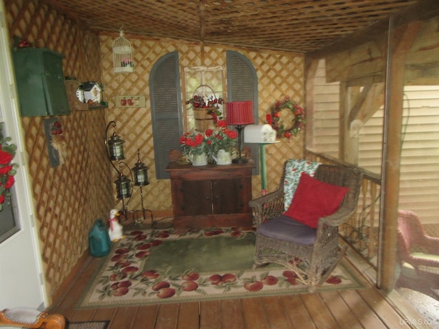 living area featuring wood-type flooring and vaulted ceiling