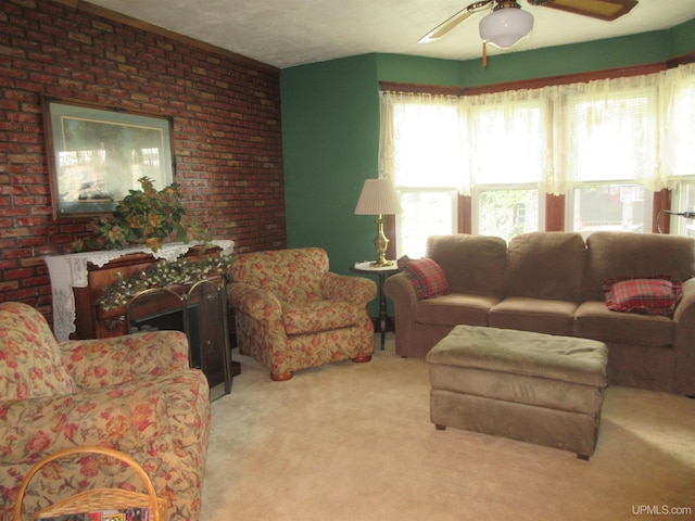 carpeted living room with brick wall and ceiling fan