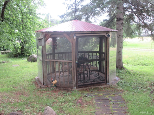 view of outbuilding featuring a lawn