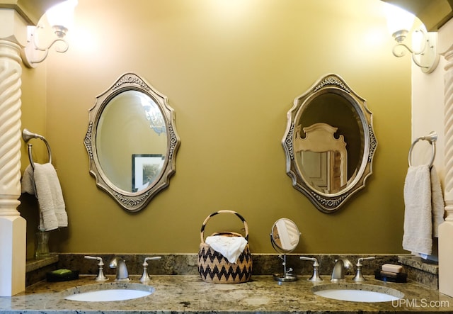 bathroom with vanity and ornate columns