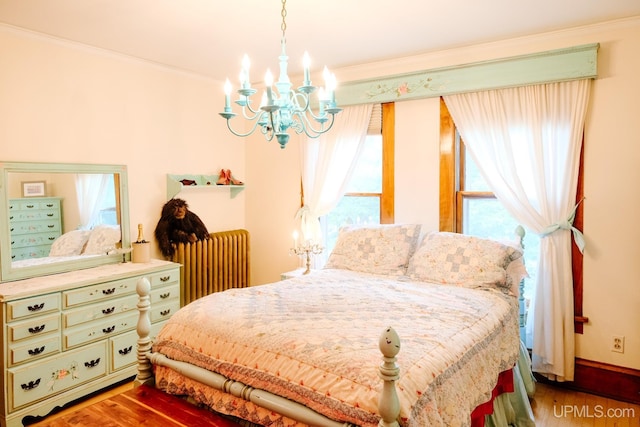 bedroom with a chandelier, dark hardwood / wood-style floors, radiator, and multiple windows