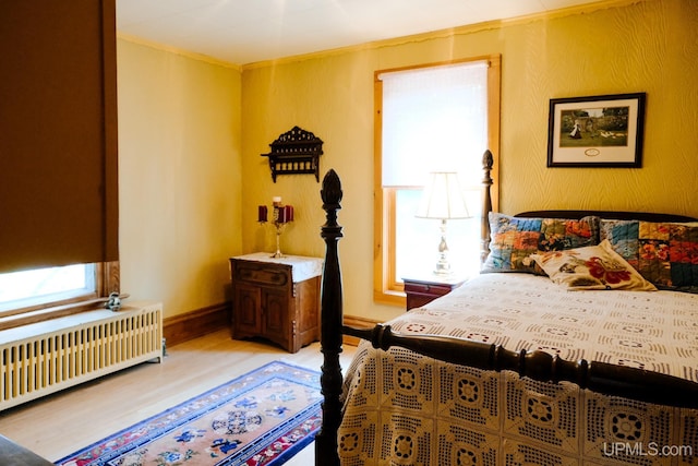 bedroom featuring radiator and light wood-type flooring