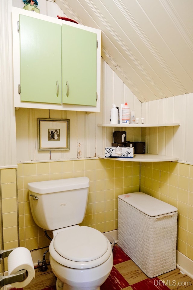 bathroom with vaulted ceiling and toilet