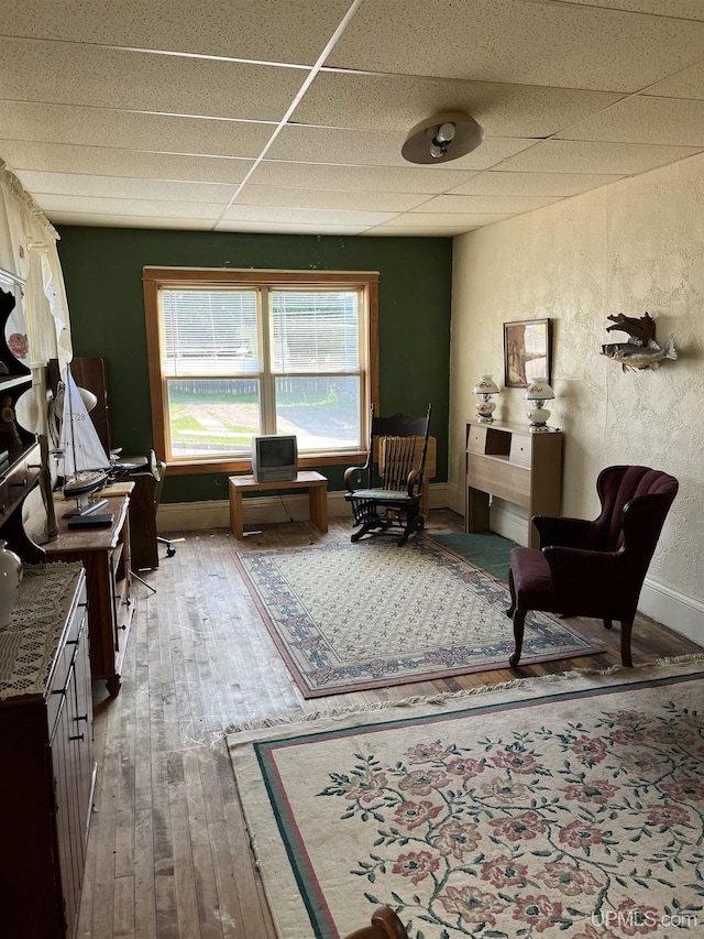 501 E N St, Ishpeming, MI 49849 - sitting room with a drop ceiling, hardwood / wood-style flooring, and a textured wall