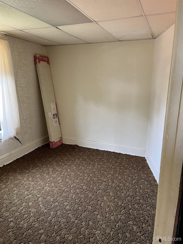 501 E N St, Ishpeming, MI 49849 - spare room with a paneled ceiling and baseboards