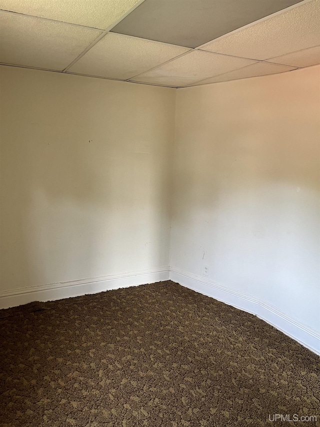 501 E N St, Ishpeming, MI 49849 - carpeted empty room featuring baseboards and a drop ceiling