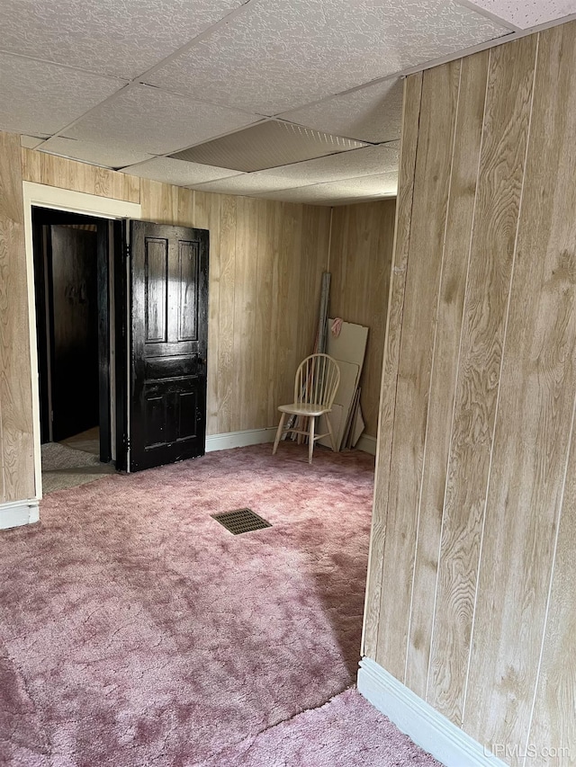 501 E N St, Ishpeming, MI 49849 - carpeted empty room featuring wood walls and baseboards