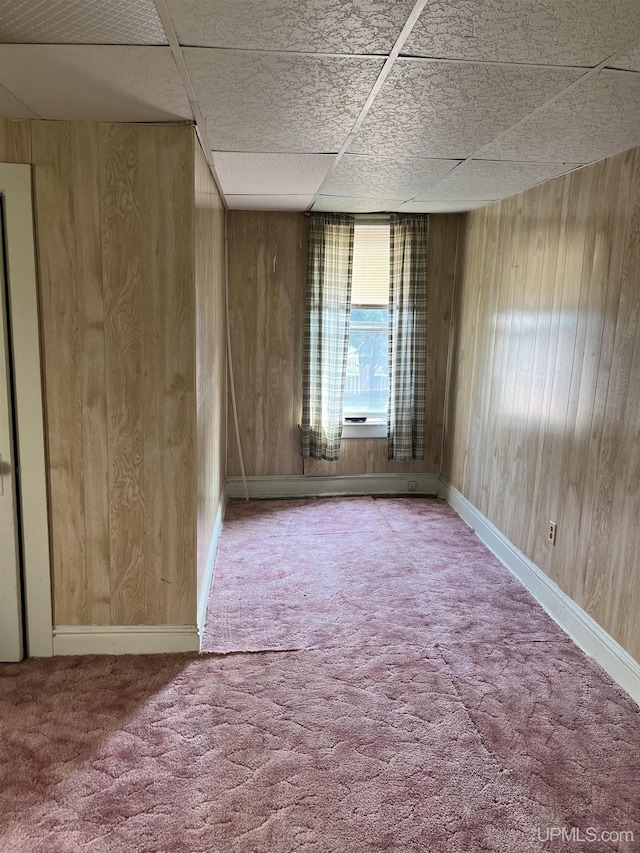 501 E N St, Ishpeming, MI 49849 - carpeted spare room featuring wood walls and a drop ceiling