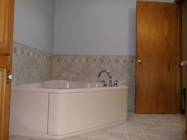 bathroom featuring a bath and tile patterned flooring