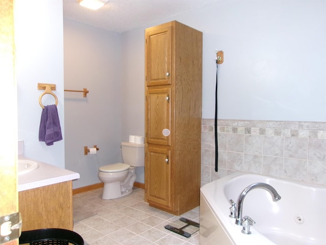 bathroom with tile patterned flooring, vanity, a bath, and toilet