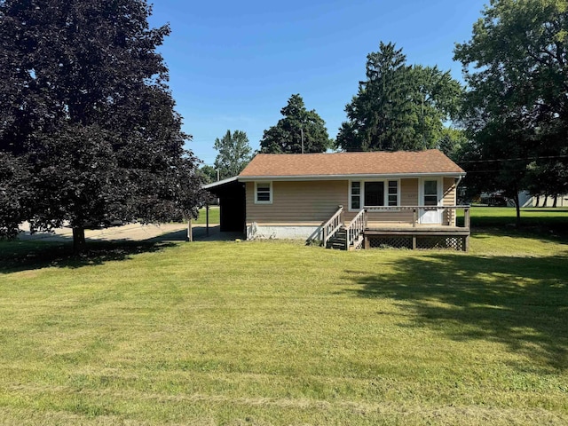 back of property with a wooden deck and a lawn