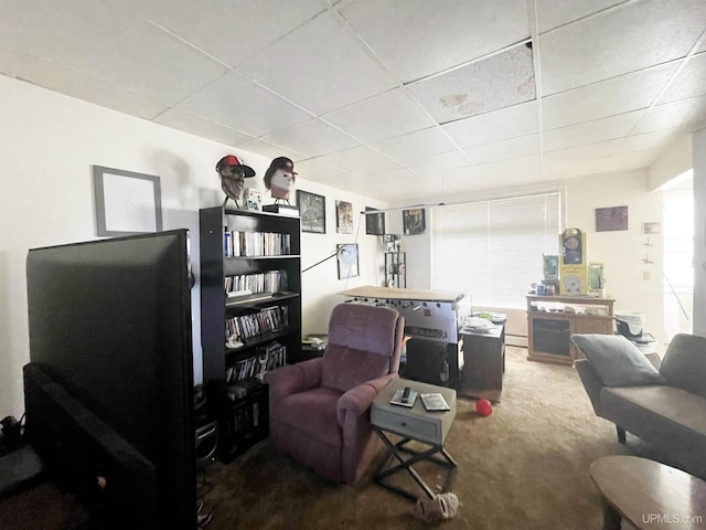 living room with carpet flooring and a drop ceiling