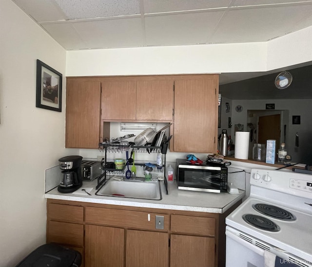 kitchen with white electric stove and sink