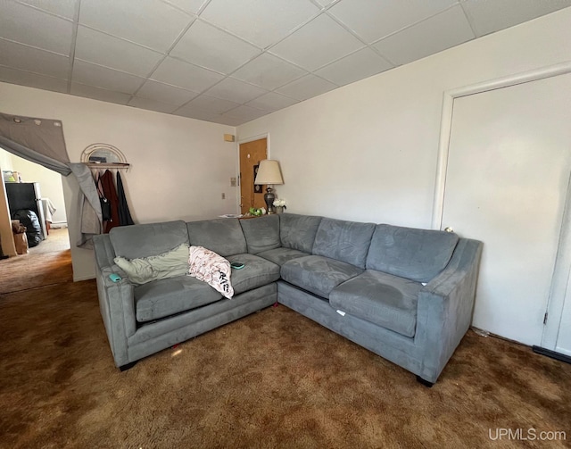 living room with dark carpet and a drop ceiling