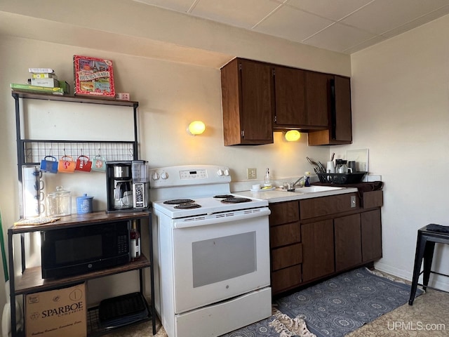 kitchen featuring dark brown cabinets, sink, and white range with electric cooktop