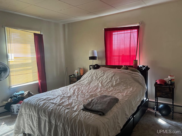 carpeted bedroom with a baseboard radiator