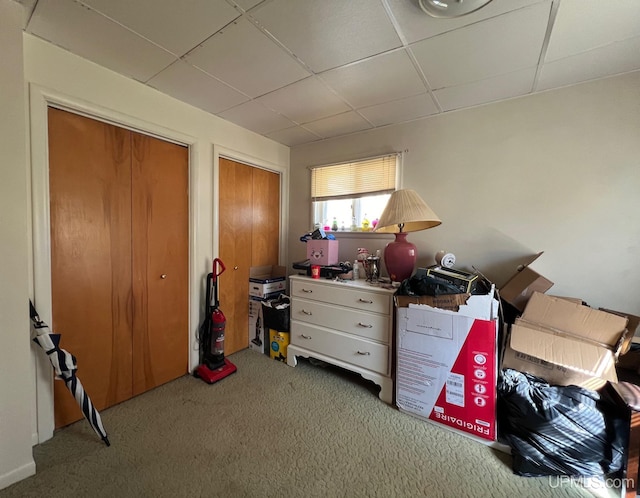 carpeted bedroom with a drop ceiling