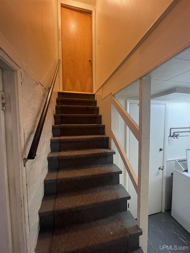 stairway with concrete flooring