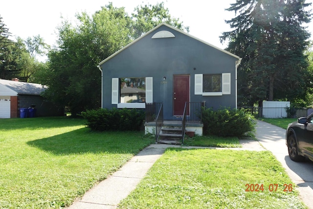 view of front of home with a garage and a front yard