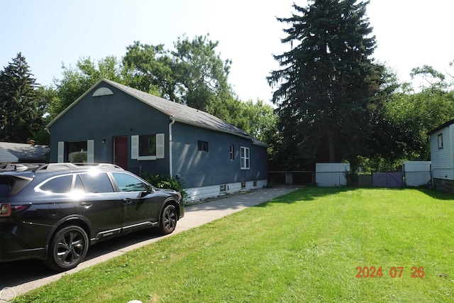 view of property exterior featuring a lawn