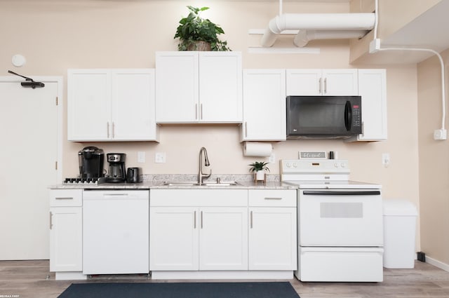 kitchen with light wood-type flooring, white appliances, white cabinetry, and sink